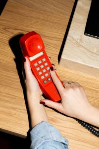 Kaboompics - Close Up Of Hand Dialing Retro Red Telephone