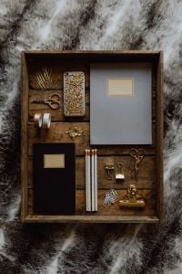 Office accessories on an old wooden tray