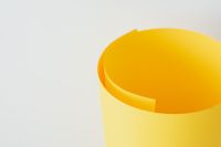 Kaboompics - Single Yellow Paper Roll with a Visible Curled Edge