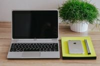 Kaboompics - Silver Acer Laptop And White Apple iPhone On Desk With Green Plant