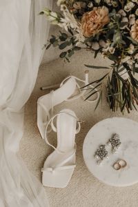 Kaboompics - White Bridal Heels and Pearl Earrings Beside a Bouquet