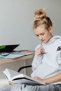 Kaboompics - Close Up of Teenager Reading Textbook