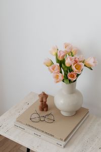 Kaboompics - Pastel Tulips and Figurine on Art Books