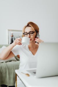 Kaboompics - Woman Holding Coffee and Phone During a Workday Break at Home