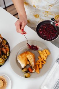 Kaboompics - Adding Cranberry Sauce to a Thanksgiving Turkey Dinner Plate
