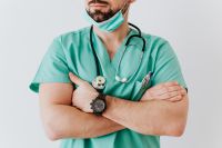 Kaboompics - Doctor in Mint Scrubs with Mask Under Chin and Stethoscope, Horizontal Healthcare Portrait