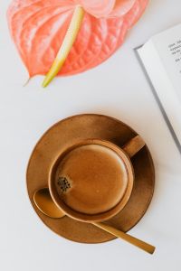 Kaboompics - Coffee Cup, Pink Anthurium and Open Book, Flat Lay