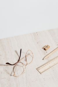 Kaboompics - Reading Glasses with Wooden Pencil, Ruler and Sharpener on Limestone for Study and Homework