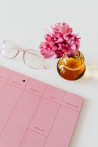 Kaboompics - Close-Up Pink Planner, Glasses and Carnation Vase for Productivity Workspace Background