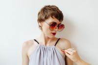 Kaboompics - Hand Applying Rainbow Paint to a Woman's Shoulder