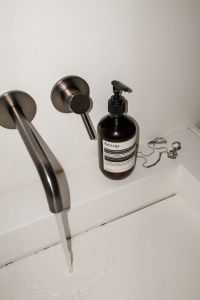 Kaboompics - Direct Flash Bathroom Product Shot with Running Sink Water