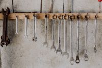 Kaboompics - Oversized Wrench and Red Screwdriver on a Garage Tool Wall
