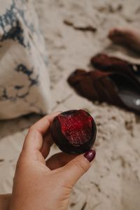 Kaboompics - Hand Holding a Red Nectarine on the Beach