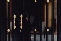 Kaboompics - Ornate Gold Door Handles on Black Double Doors, Madrid Architecture Detail