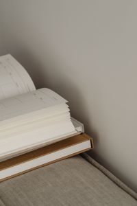Kaboompics - Home Office Planning Supplies: Open Planner and Notebooks on a Neutral Sofa