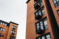 Kaboompics - Corner View of Brick Apartments with Stacked Black Balconies
