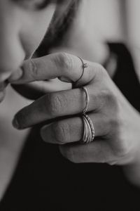 Kaboompics - Black and White Close-Up of Woman's Ringed Hand Near Face