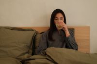 Kaboompics - Woman Cozy in Bed with Pillow and Morning Beverage