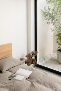 Kaboompics - Open Book and Dried Flowers on Gray Bedding