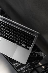 Kaboompics - Macbook Pro laptop - marble - decorative plaster on wall - black aesthetics
