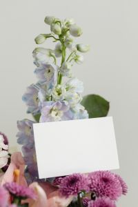 Kaboompics - Vertical Blank Card beside Pale Blue and Lavender Flowers on Soft Background