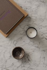 Kaboompics - Black Candle, Stone Ring Dish and Design Book on Marble