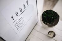 Kaboompics - Small wooden table with a potted plant and a grey wallet