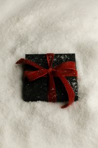 Kaboompics - Black Christmas Gift Box with Red Bow on Artificial Snow