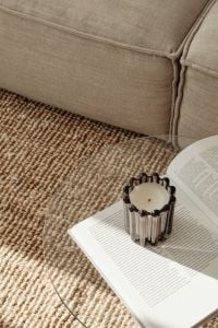 Kaboompics - Black Glass Candle on Open Book beside Gray Sofa and Jute Rug
