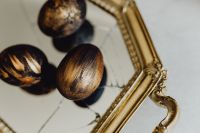 Kaboompics - Close-Up of Black and Gold Easter Eggs on an Ornate Gilded Tray