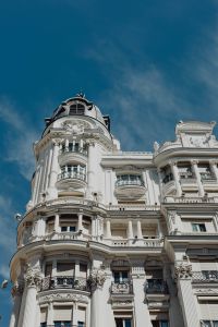 Kaboompics - Ornate White Madrid Corner Facade and Curved Balconies Against Blue Sky