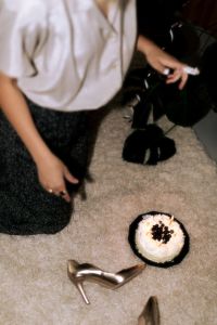 Kaboompics - Top-Down Woman Reaching toward Birthday Cake on a Carpet