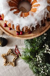 Kaboompics - Iced Bundt Cake with Red Berries and Evergreen Wreath