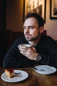 Young Elegantly dressed man sititng in a cafe
