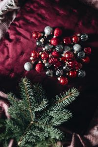 Kaboompics - Burgundy Christmas Still Life with Baubles, Greenery and Warm Lights