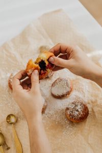 Kaboompics - Cherry Jam Revealed as Hands Pull Apart a Polish Paczki, Sweet Food Close-Up