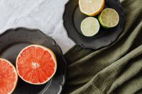 Red Grapefruit with Lemon and Lime on Black Ceramic, Olive Linen Food Styling