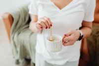 Kaboompics - Stirring a Cup of Coffee During a Home Office Break Between Online Orders