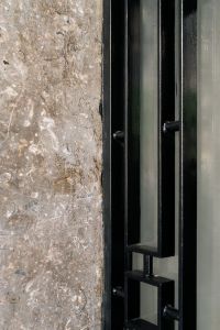 Kaboompics - Black Metal Door Detail with Stone Facade