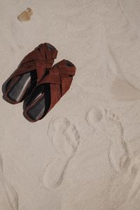 Kaboompics - Brown Leather Sandals and Footprints in the Sand