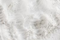 Kaboompics - Wide White Cream Swirls Scattered with Dark Specks, Skincare Texture Background