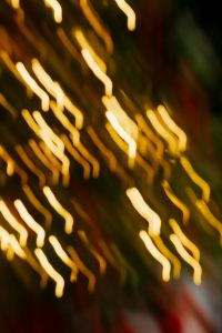 Kaboompics - Christmas Tree Bokeh Light Trails with Red Presents and Dark Green Decor