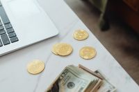 Kaboompics - Bitcoin Coins and Cash Beside Laptop