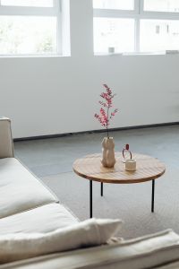 Kaboompics - Wooden Coffee Table with Candle and Vase by White Sofa