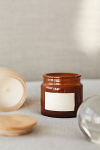 Kaboompics - Close-Up Amber and Cream Candle Jars with Blank Labels