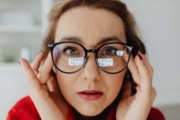 Kaboompics - Woman Adjusting Glasses with Both Hands during a Home Office Break