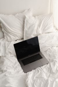 Kaboompics - Laptop Centered on a White Bed with Pillows