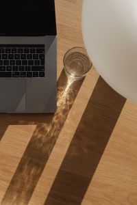 Kaboompics - Water Glass Next to Laptop on a Sunlit Home Office Desk
