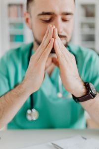 Kaboompics - Doctor Resting Hands at Office Desk