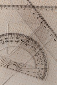 Kaboompics - Layered Transparent Measuring Tools on Orange Graph Paper